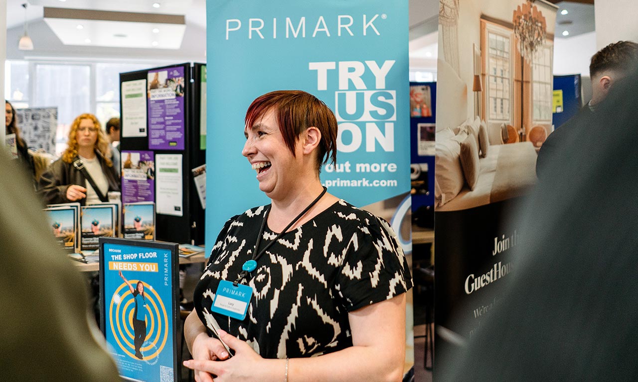 Representative next to Primark roller banner at Jobs Fair 
