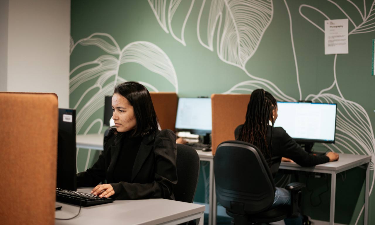 Students working on desktop computers at London Campus. 