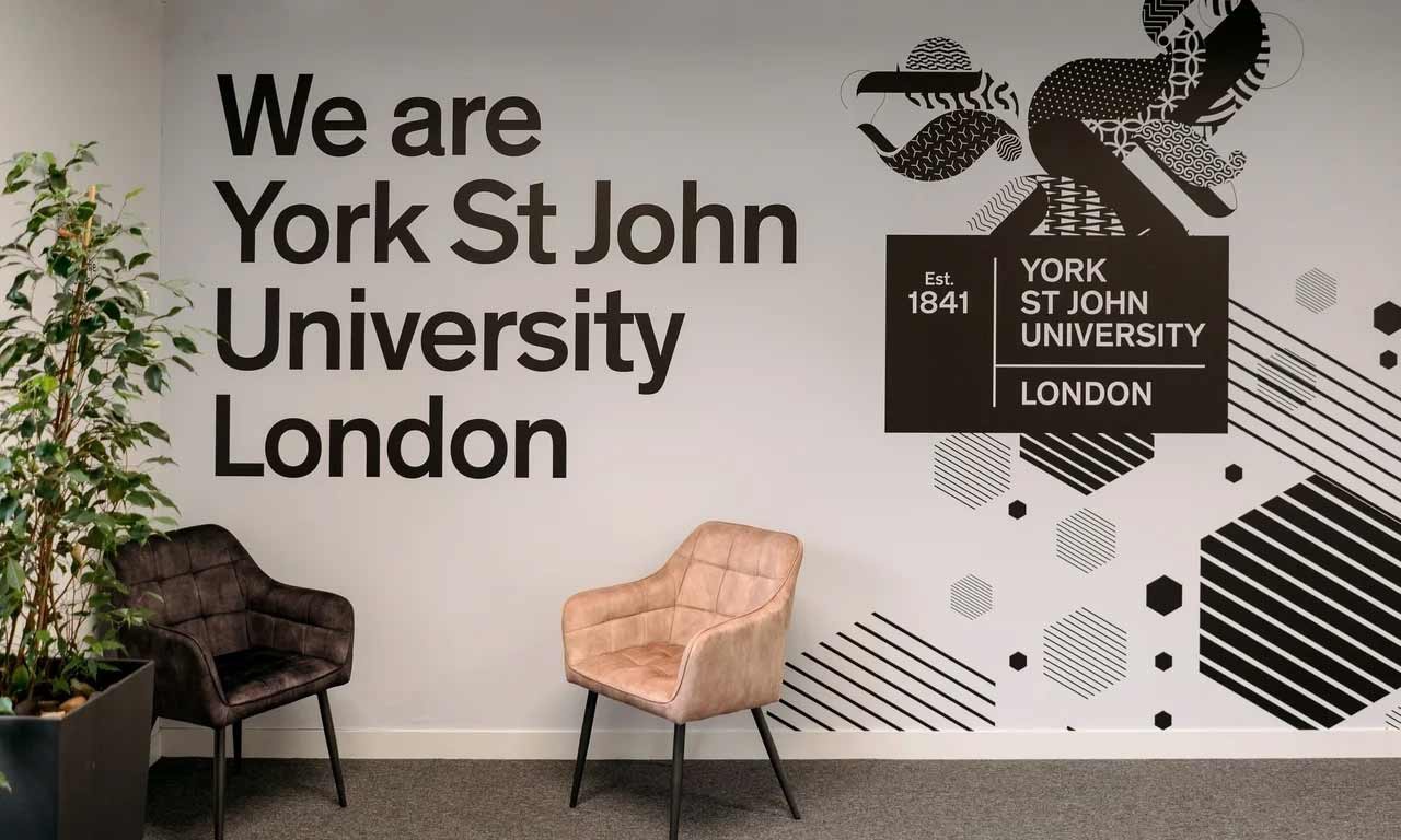 Interior of YSJ London Campus with welcome sign and seating. 