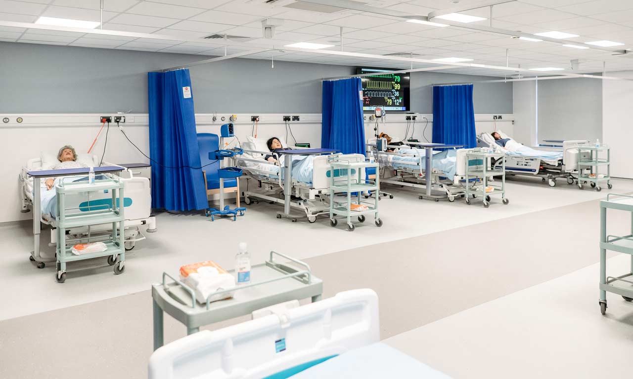 Specialised nursing and health teaching ward, with hospital beds and medical equipment. 