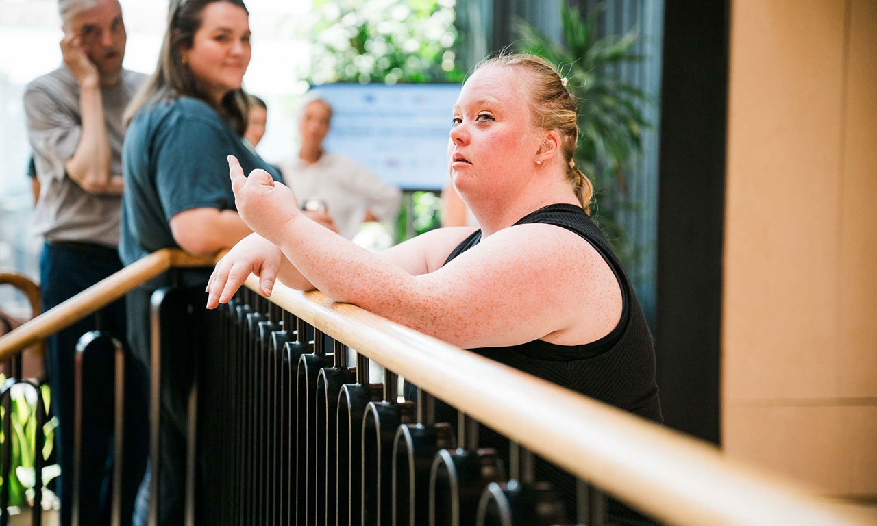 Artist leaning on balcony in Creative Centre 