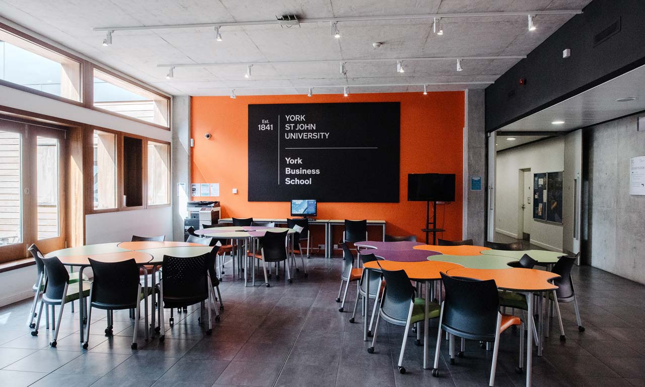 Classroom with grouped tables and chairs for small group work. 