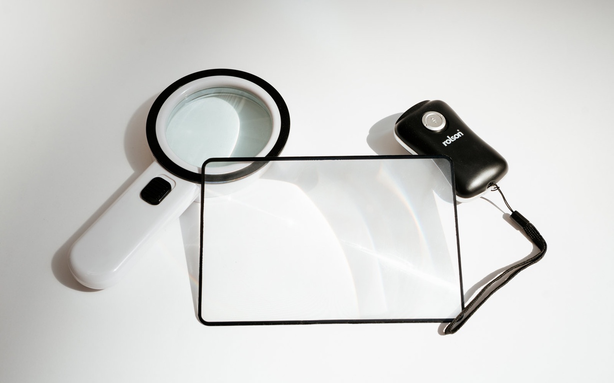 A magnifying glass, magnifying sheet, and torch. 