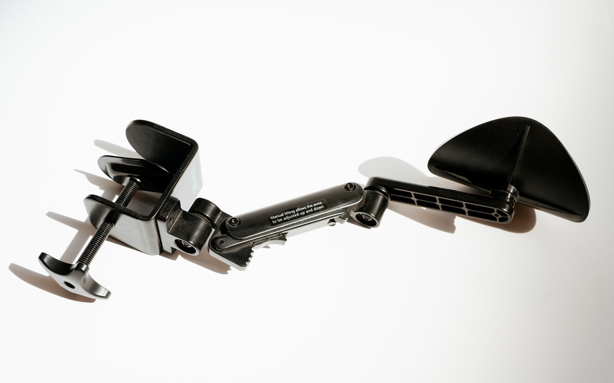 Arm rest with clamp that can be attached to a desk. 