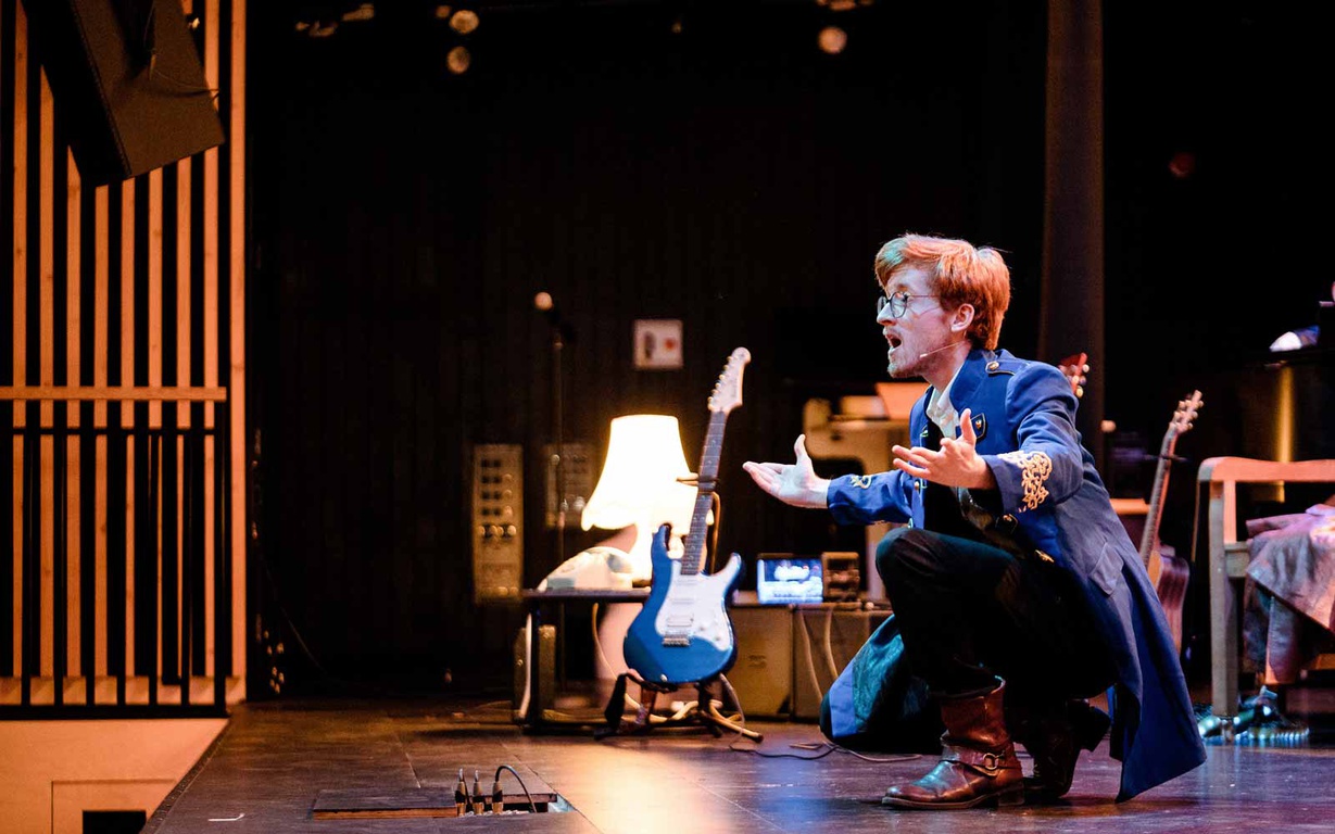 A drama student performing on the stage in York St John University's Creative Centre auditorium. 