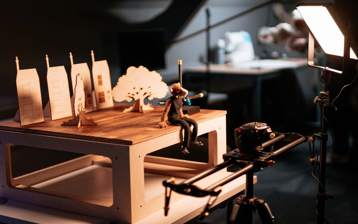 A stop motion animation booth with puppet, set, camera and lighting. 