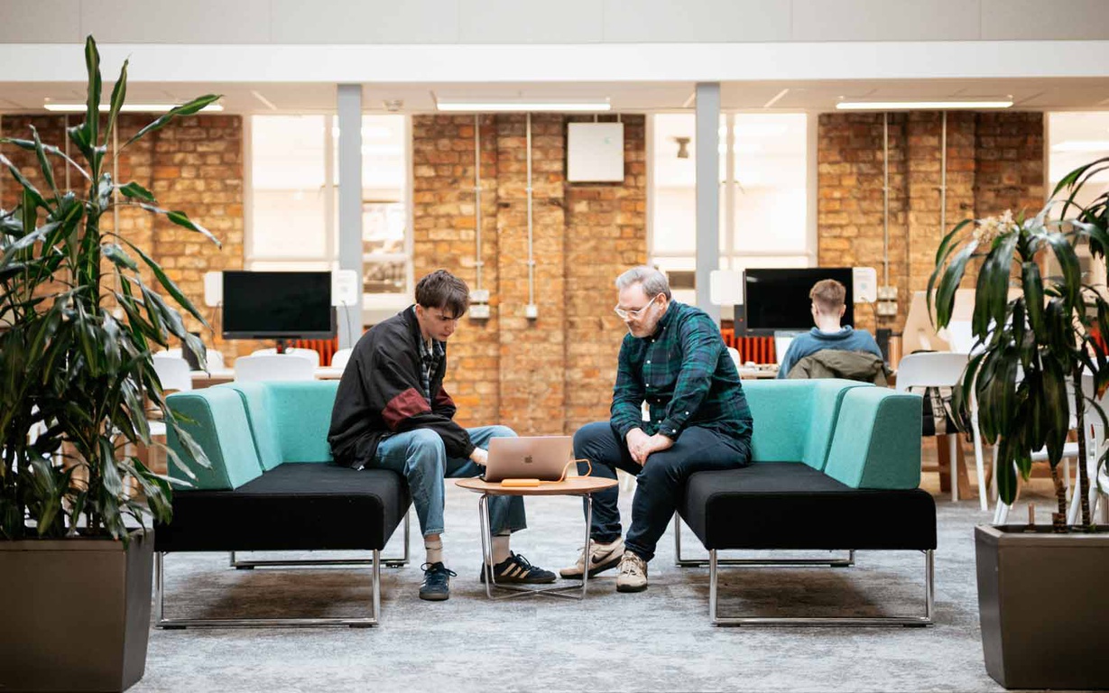 A student and lecturer sat in the Design Centre's seating area. 