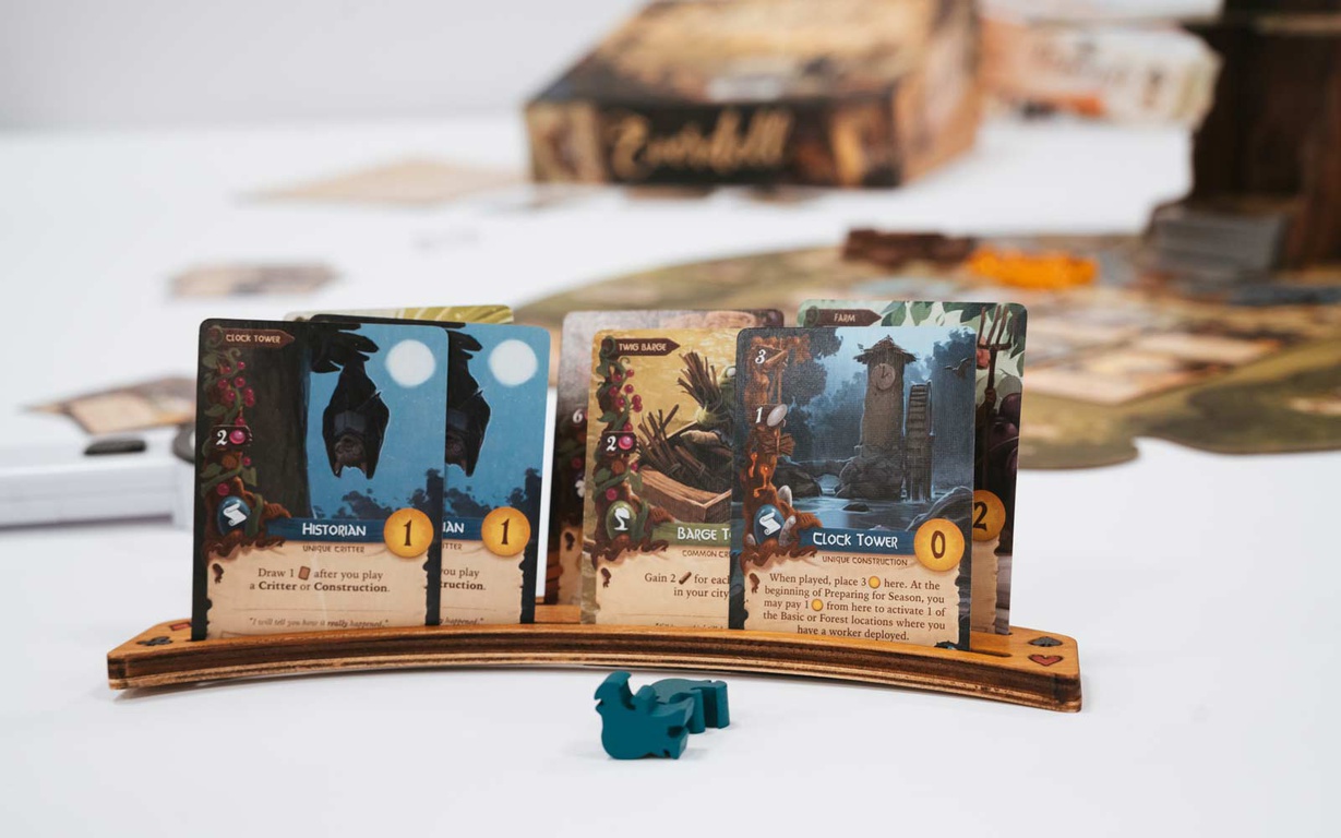 Cards and player pieces for the game Everdell. 