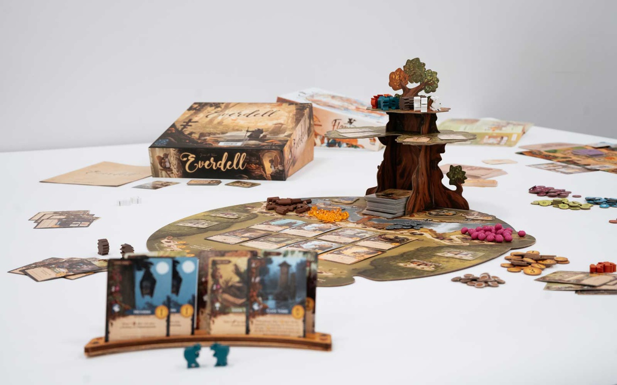 The board, cards, player pieces and box for the game Everdell. 