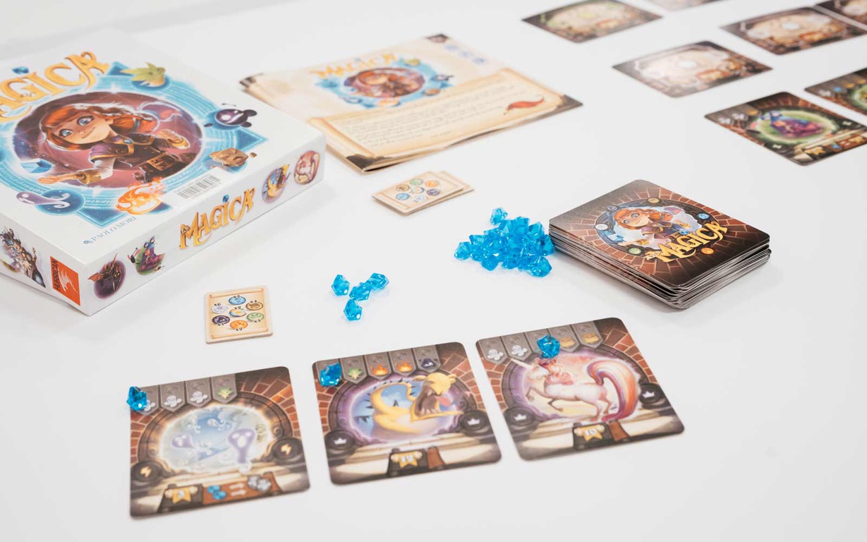 The box, cards and pieces for the game Magica. 