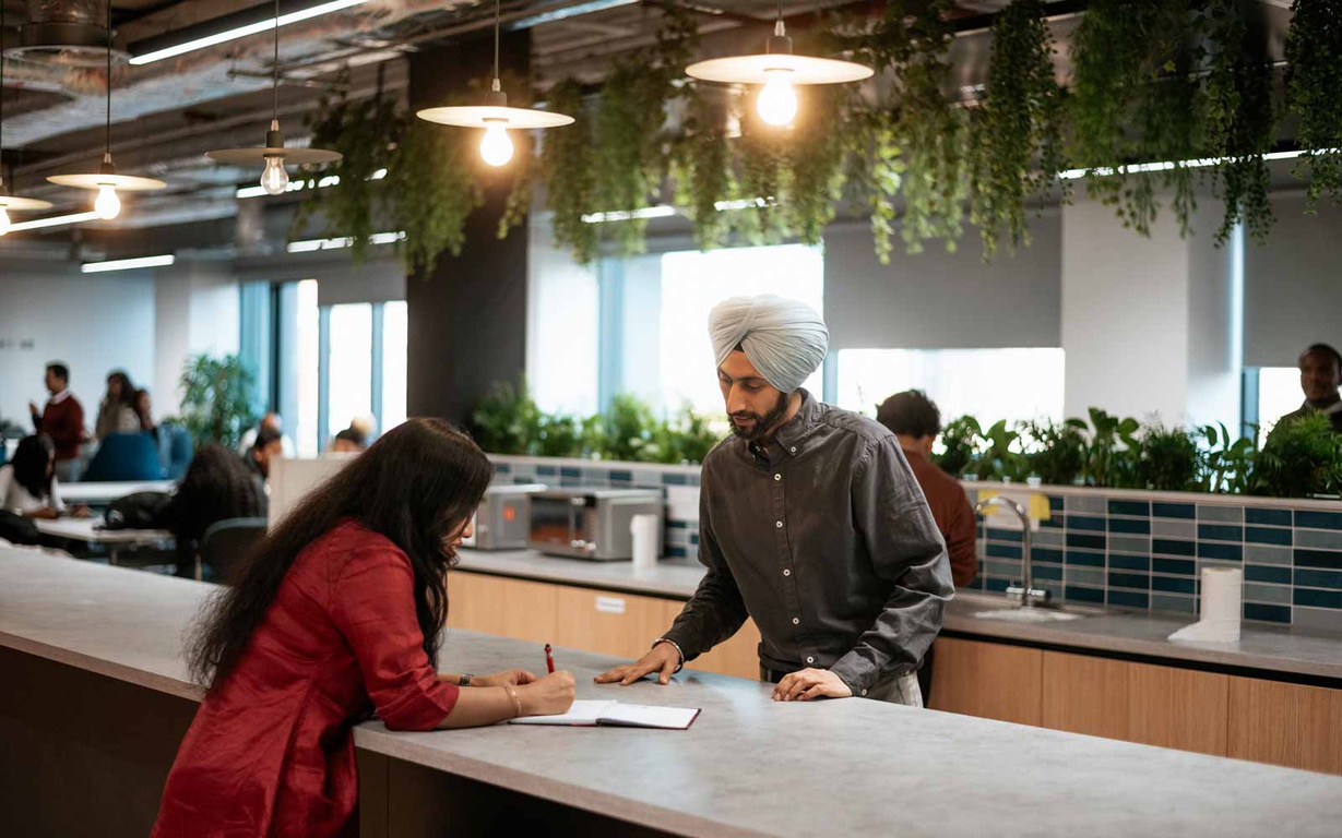 Students socialising in a kitchen at the London campus. 