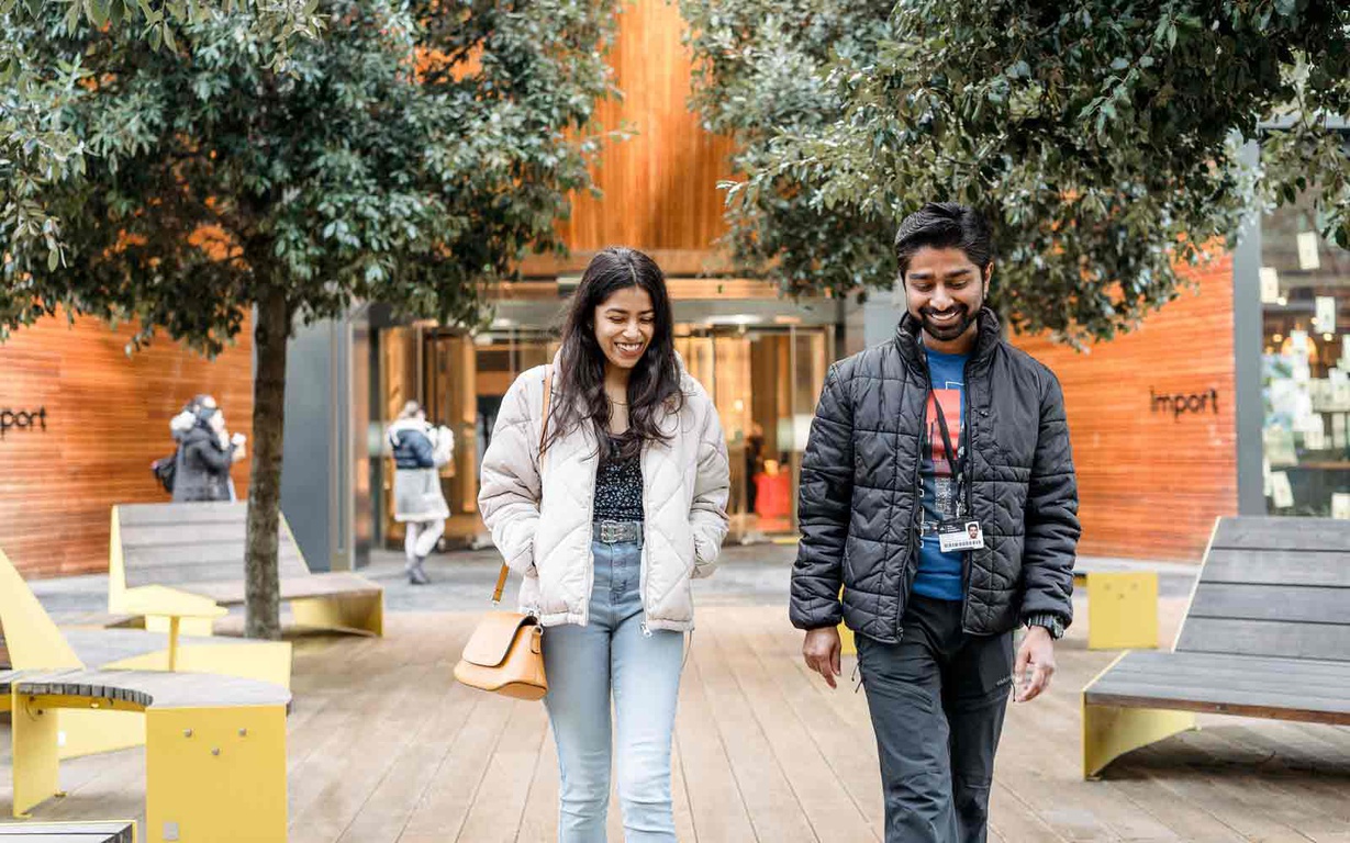 Two students walking through our London campus. 