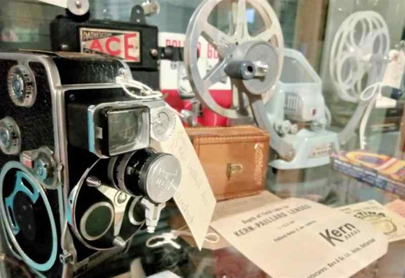 a close up of vintage videography equipment including a camera and tape reels 