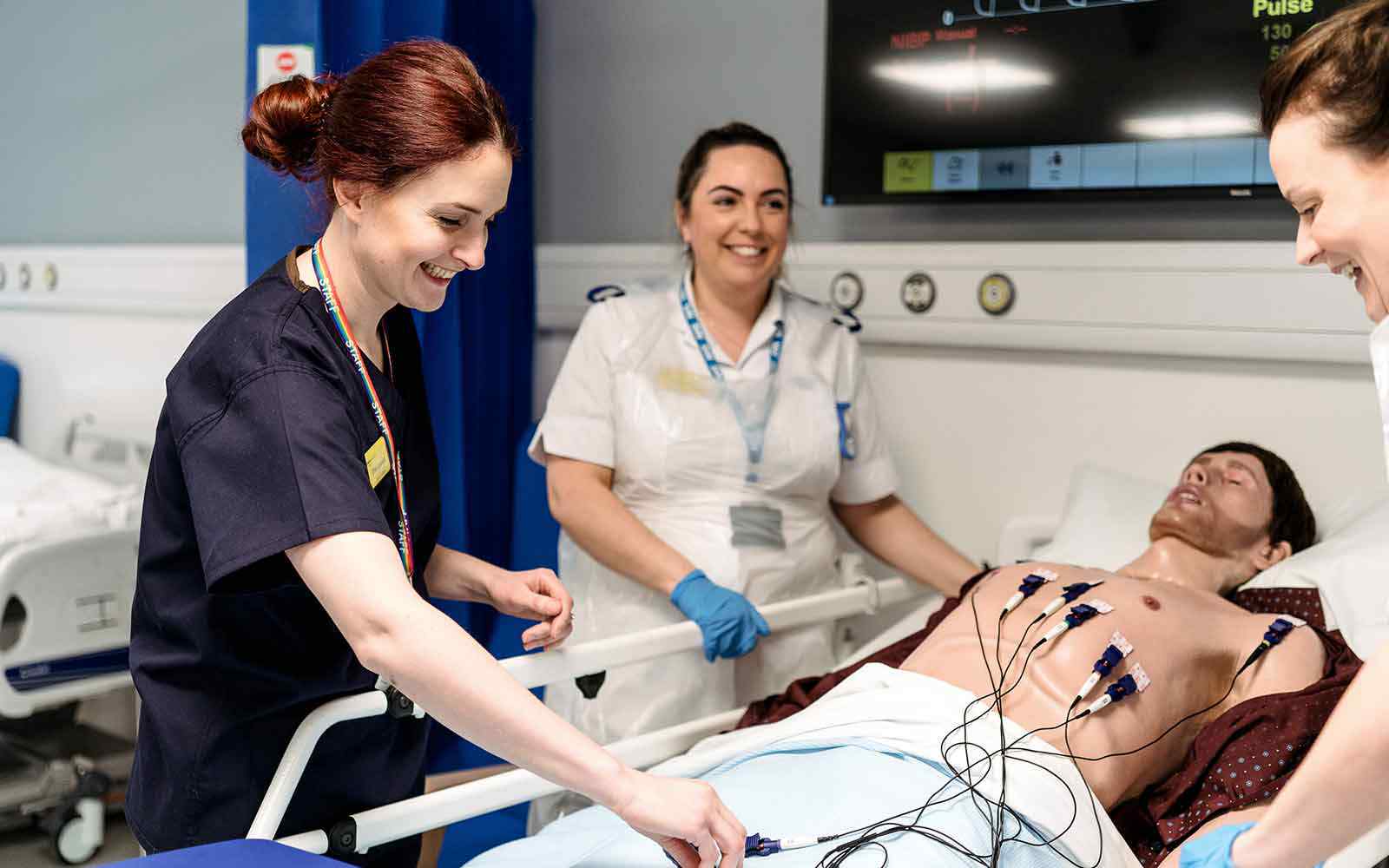 Nursing students working with a manikin. 