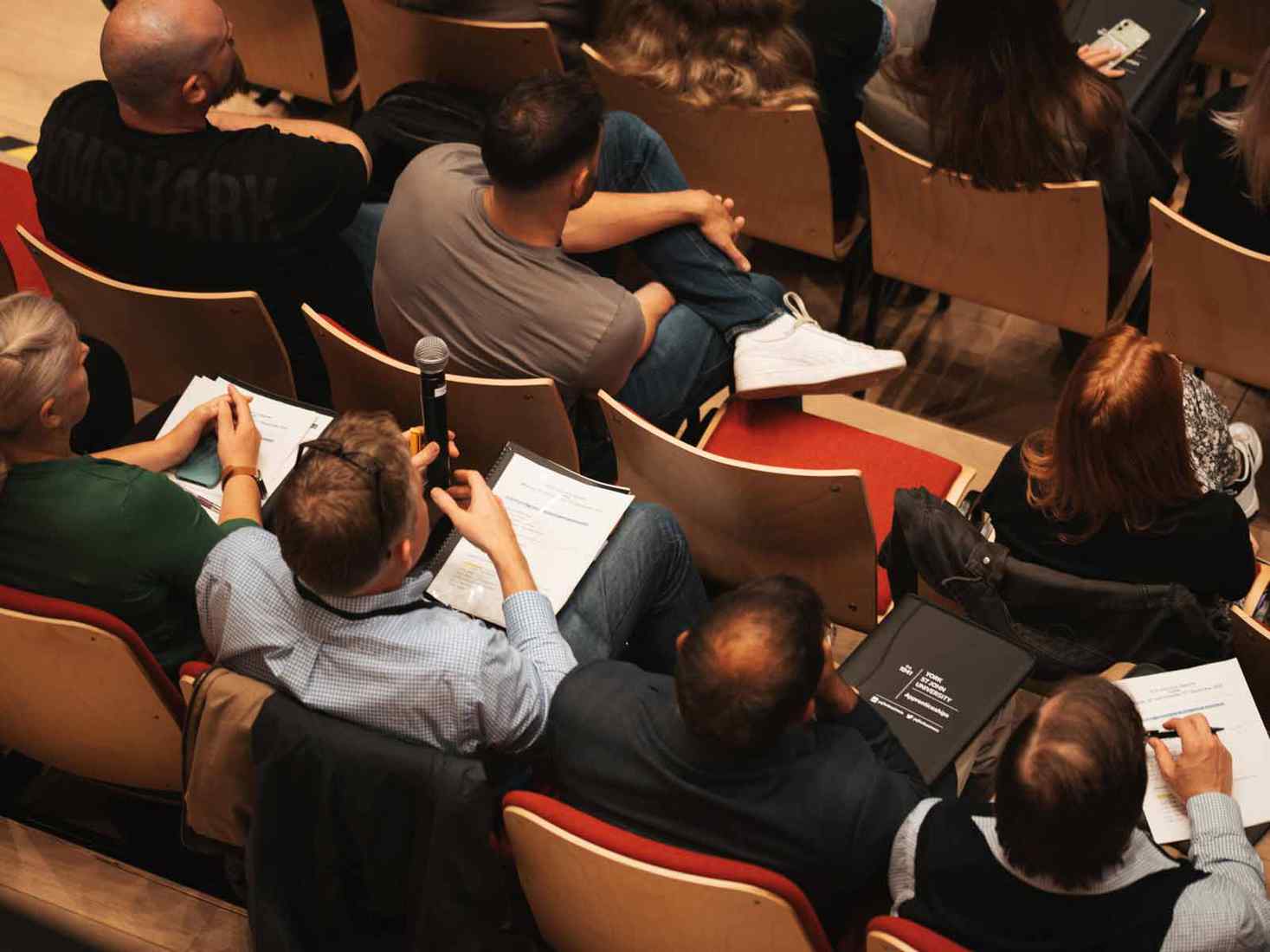 Overhead view of students listening to induction talk. 
