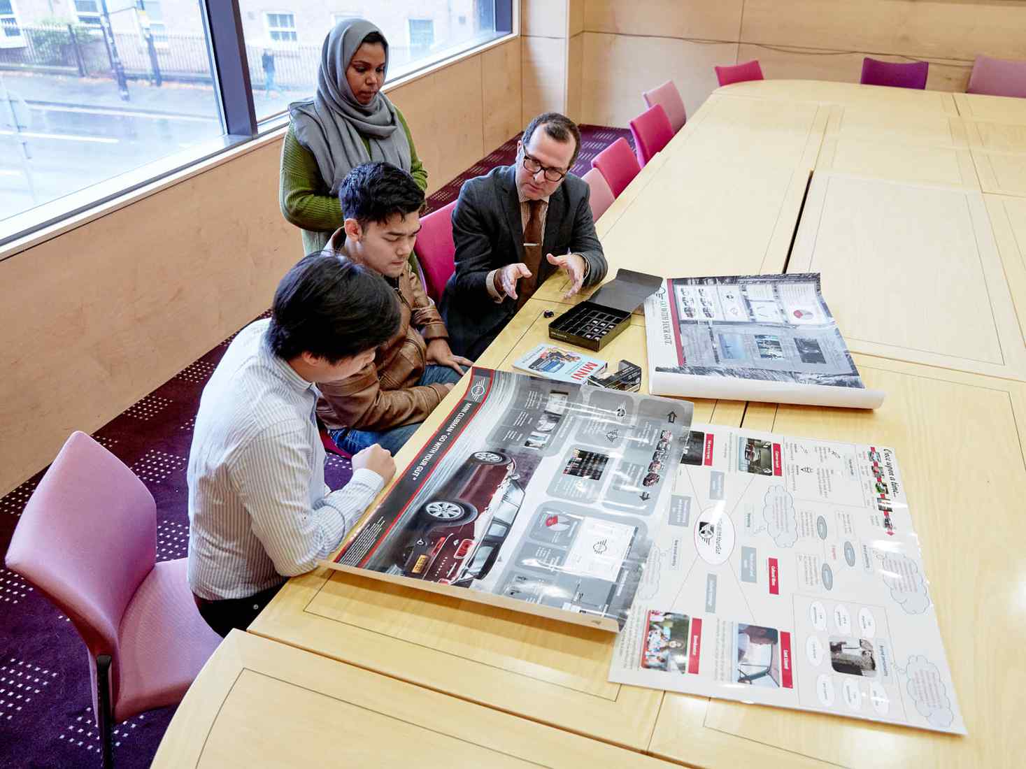 Students discussing marketing materials 
