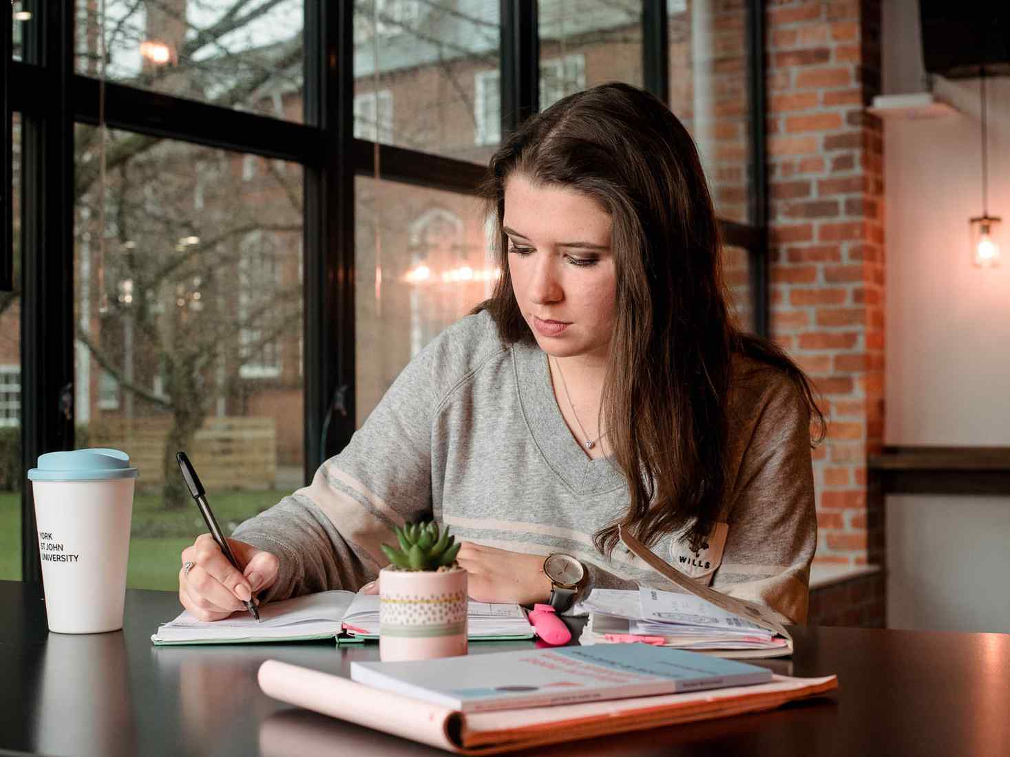Student writing in notebook 