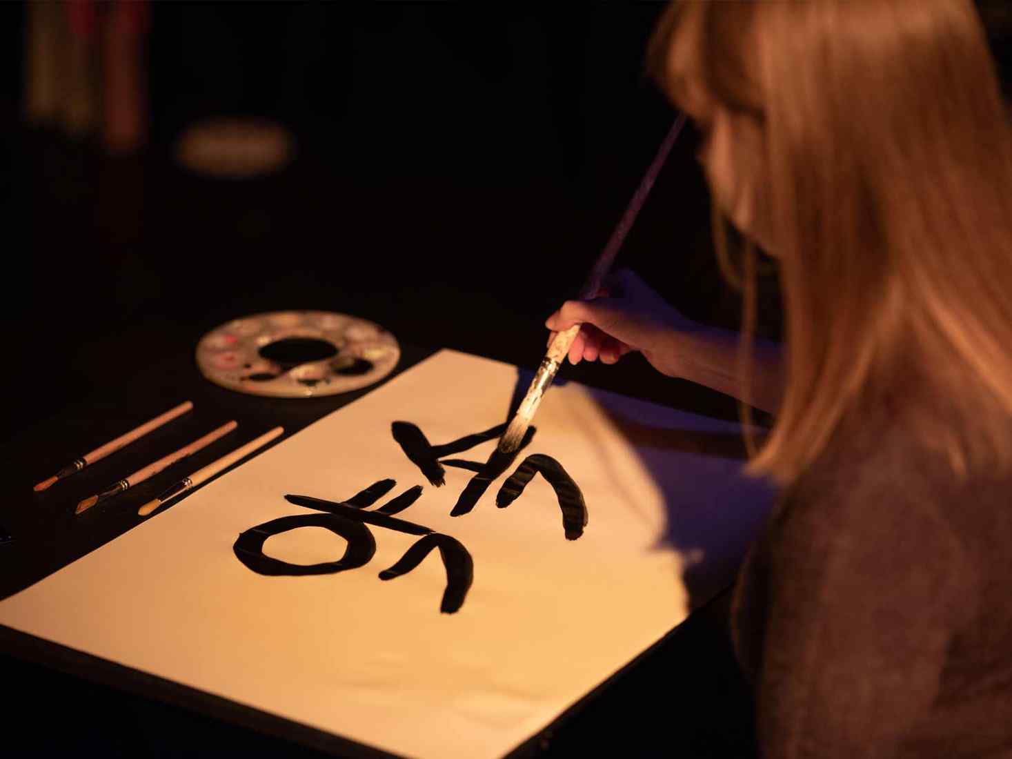 Student writing in Hangeul Korean alphabet. 