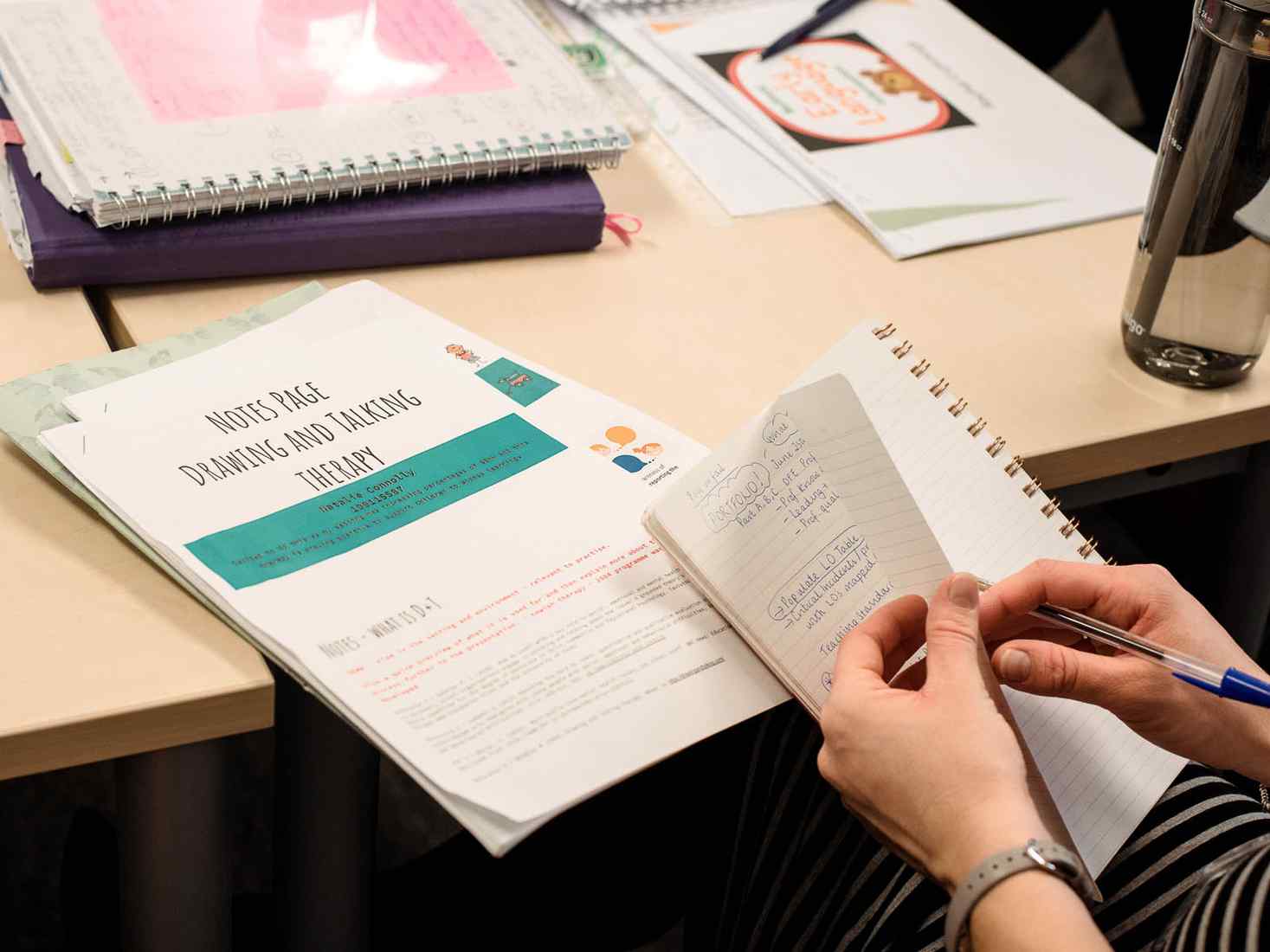 Student taking notes on drawing as therapy workshop 