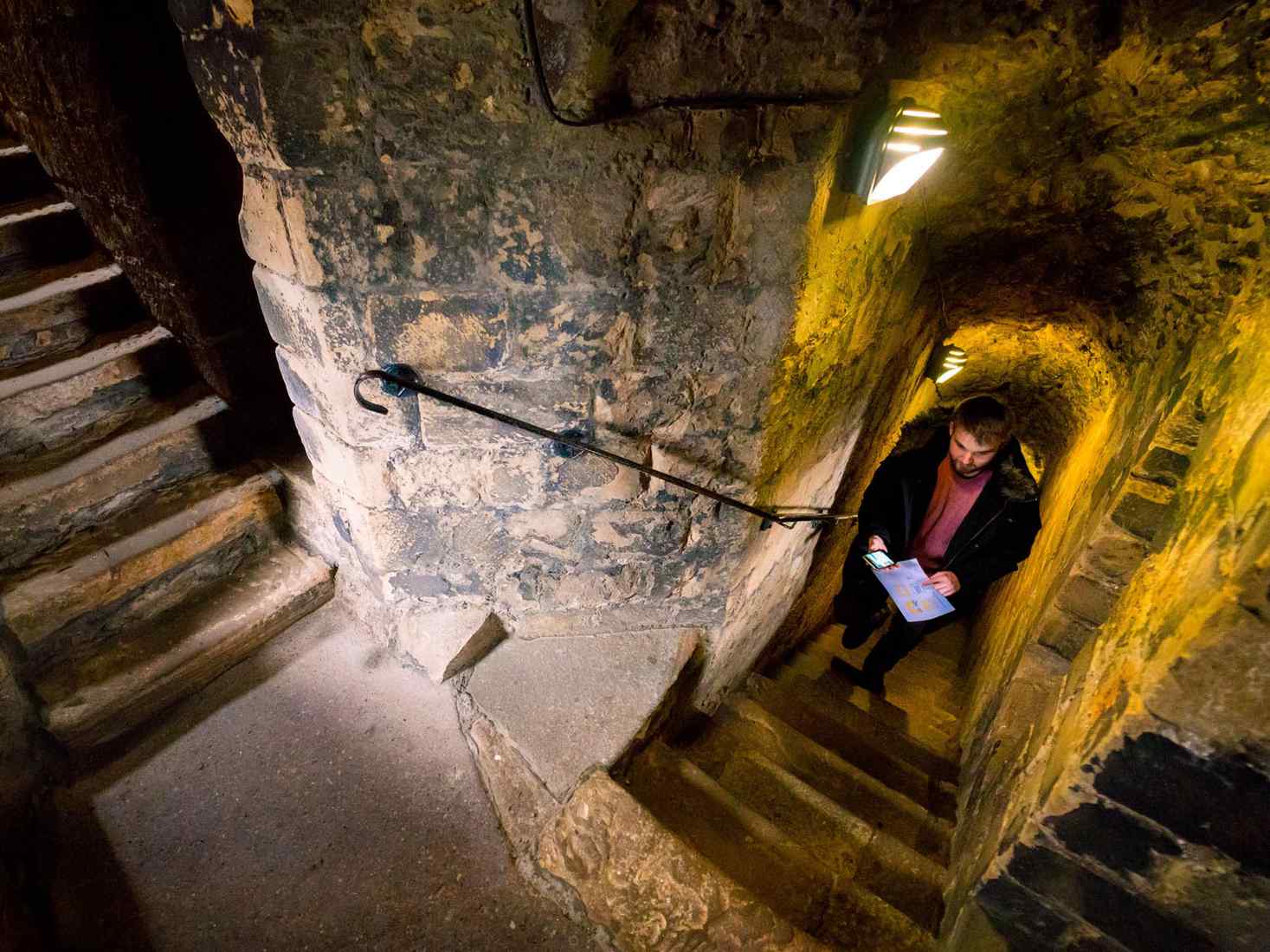 Student walking up stairs in castle 