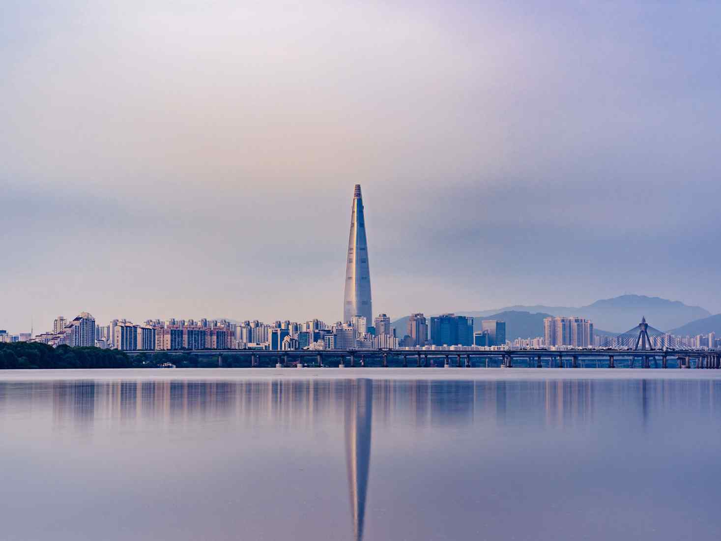 Seoul city skyline across water. 
