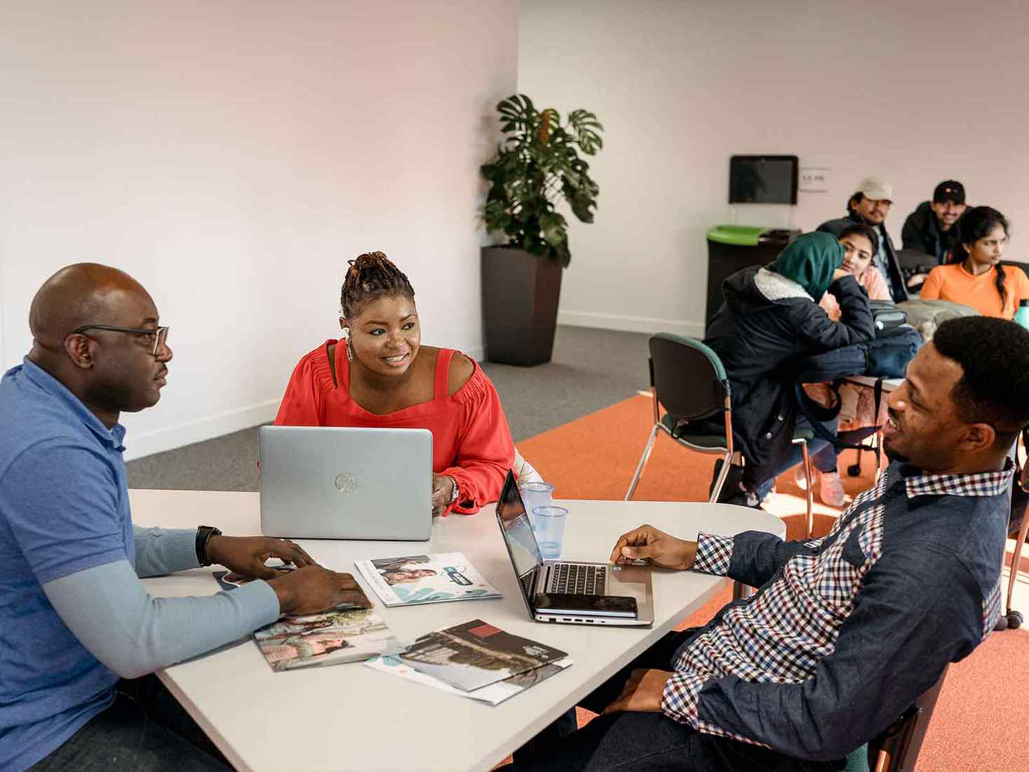 Students in a discussion around a table. 