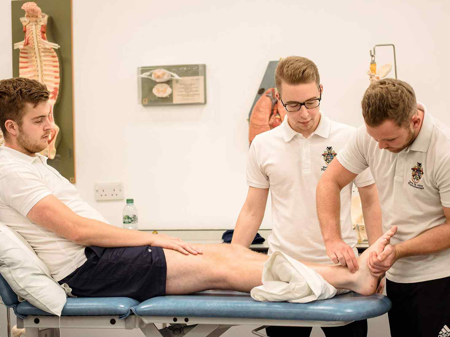 three students doing practical work 
