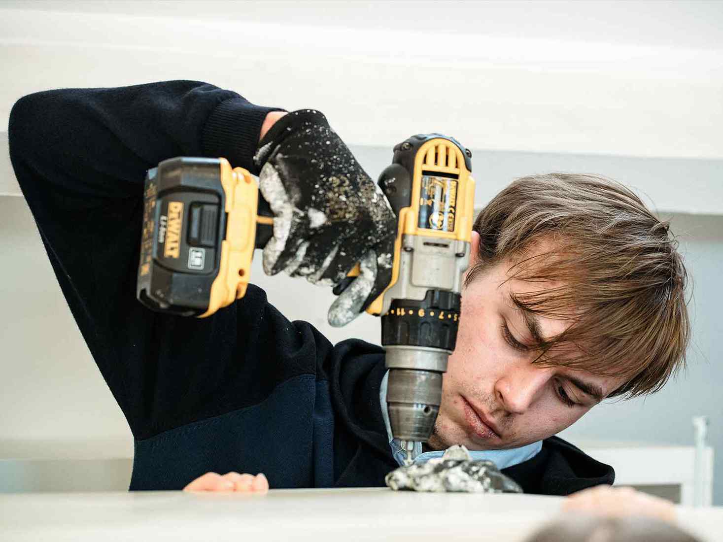 A student using a drill 