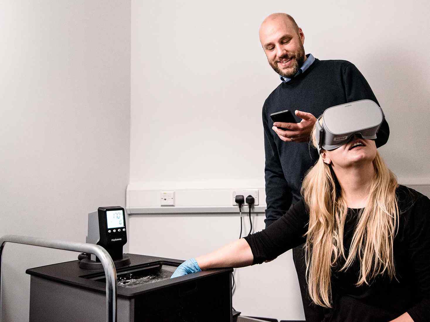 lecturer and student using the psychology equipment 