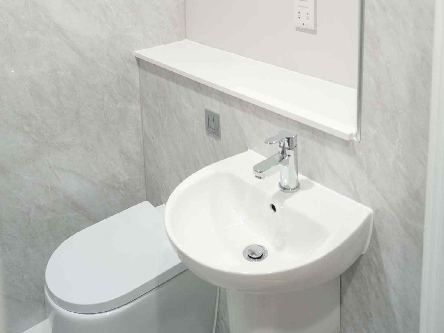 An image of a bathroom in 79 Clarence Street accommodation, including a toilet and sink 