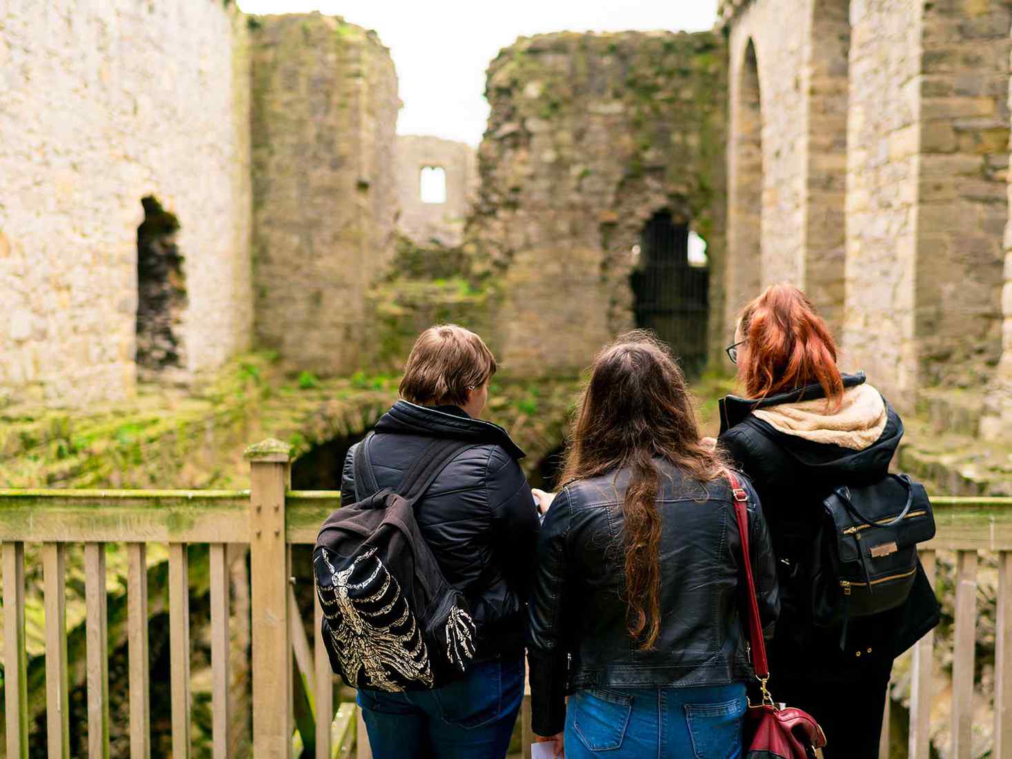 three students looking away form the camera 