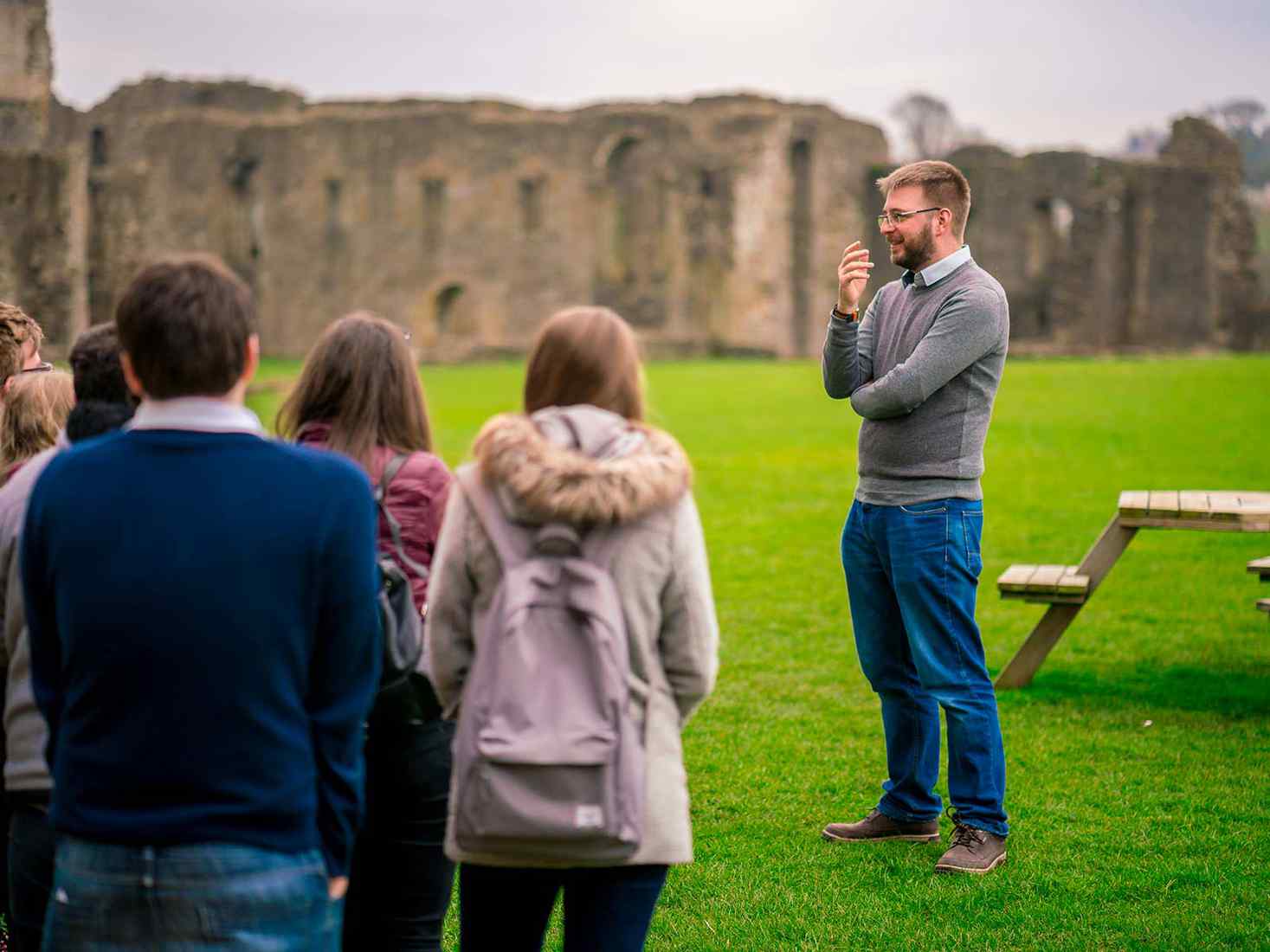 male lecturer talking to students on a field trip 