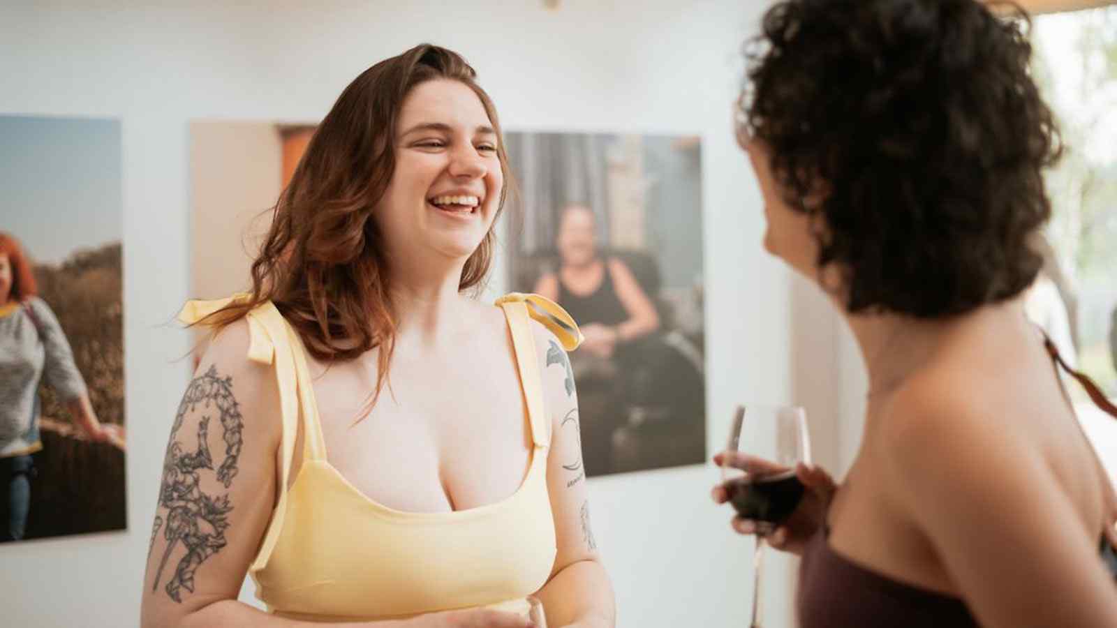 Two people speaking at an art exhibition. 