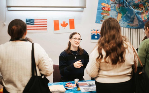 A study abroad staff member talking to students. 