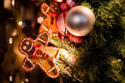 Close up shot of a gingerbread ornament on a Christmas tree 