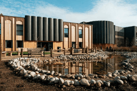 Image of the Design Centre building with pond and plants in front. 