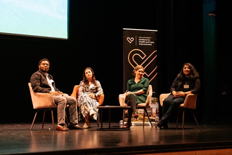 A group of people sitting together on stage at the Institute for Health and Care Improvement showcase event in June 2026 