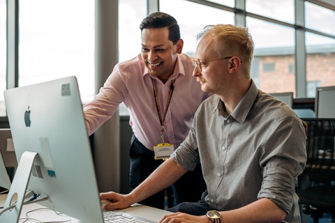 A library staff member assisting a student. 