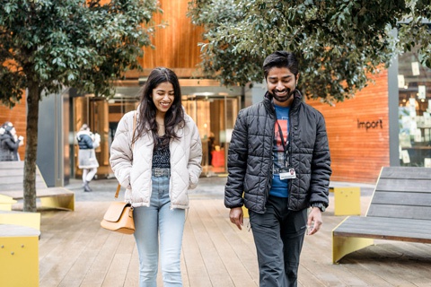Two students walking through York St John University London campus. 