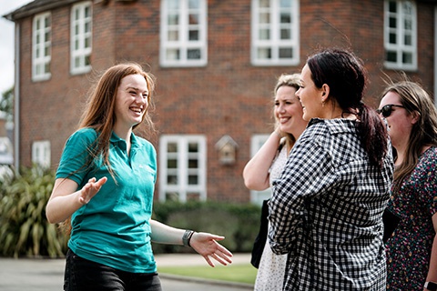 Student Ambassador talking to prospective students on campus tour 