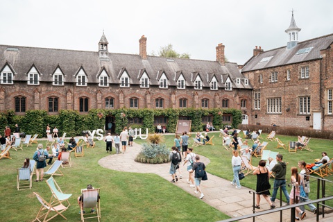 Prospective students on the York St John University Quad building's lawn. 