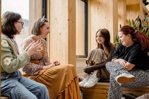 Four students sitting together in the Creative Centre 