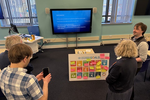 People working on a group task during an event meeting. 