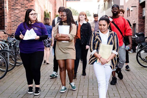 Group of individuals walking together across York Campus 
