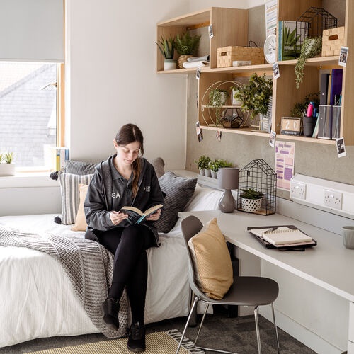 Student in a bedroom at an accommodation site 