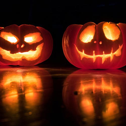 Carved pumpkins lit up in the darkness 