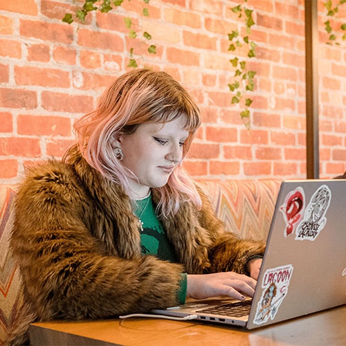 Student working on laptop in Students' Union 