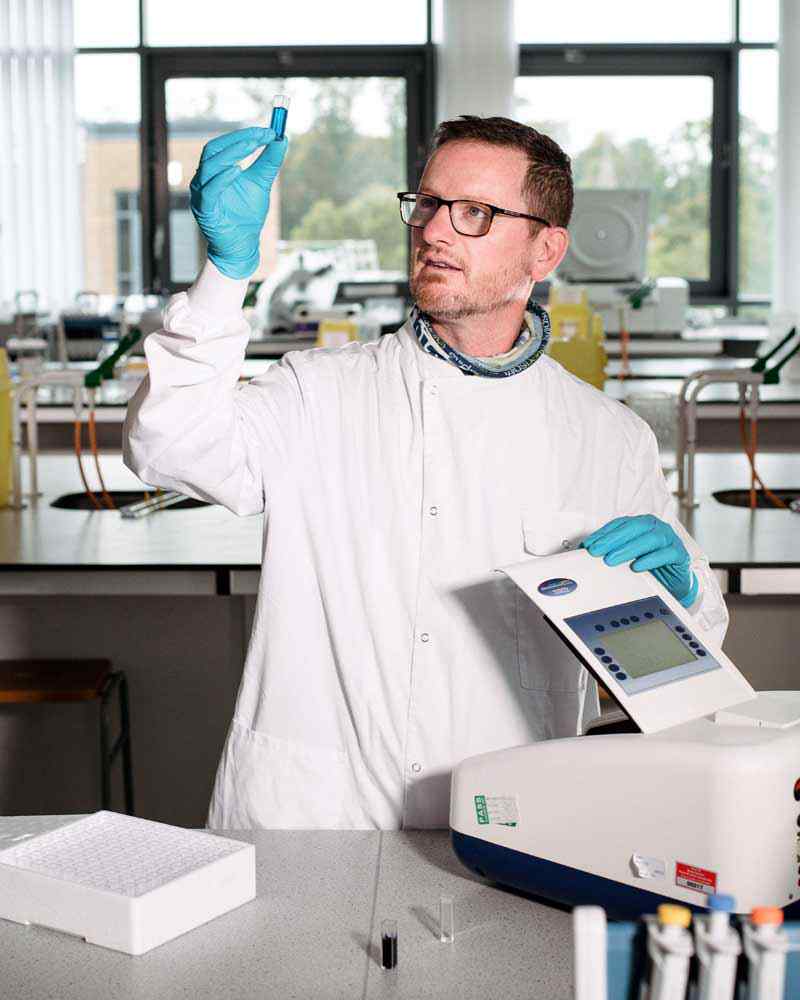 A biomedical student works in a lab. 