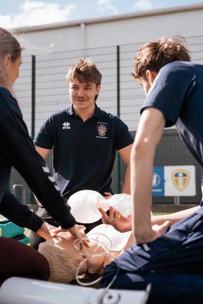 Sports students in situation on the pitch. 